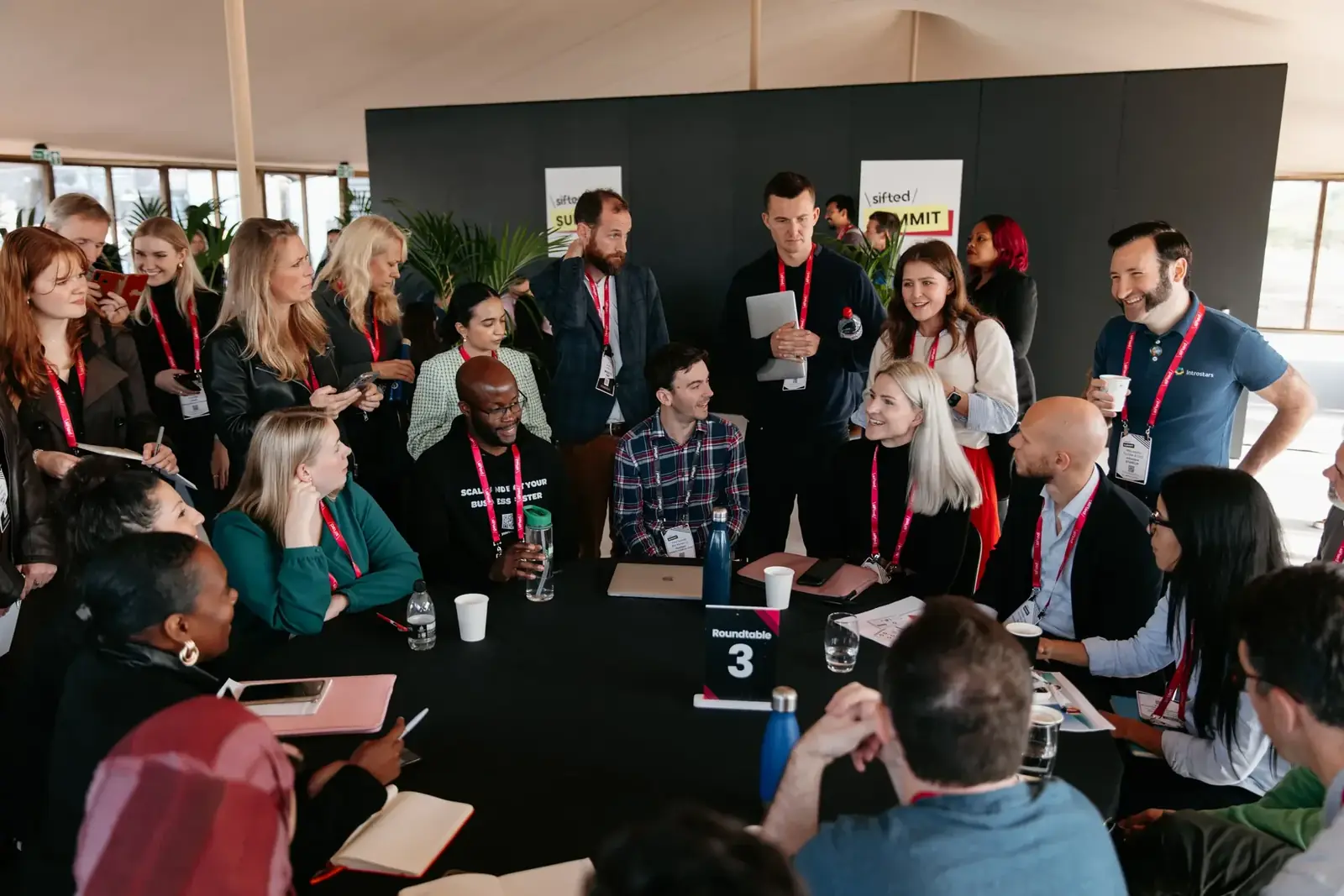 Attendees in conversation in the main hall at Sifted Summit 2026